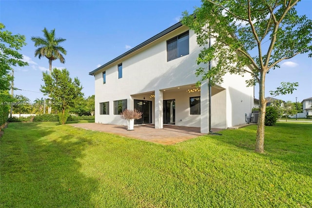 13005 Addilyn Ct, Davie, FL 33325 - back of property with a patio area, stucco siding, and a yard