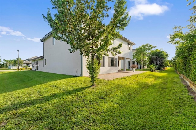 13005 Addilyn Ct, Davie, FL 33325 - back of property featuring a patio area, a lawn, and stucco siding