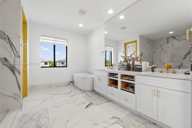 13005 Addilyn Ct, Davie, FL 33325 - full bathroom featuring double vanity, a freestanding tub, recessed lighting, marble finish floors, and a marble finish shower