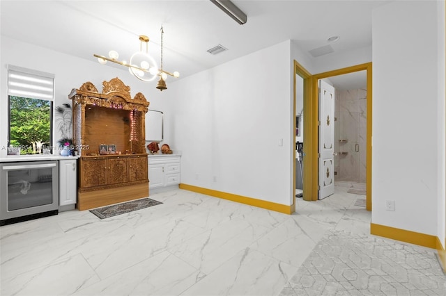 13005 Addilyn Ct, Davie, FL 33325 - interior space with light marble finish floors, a chandelier, wine cooler, and pendant lighting