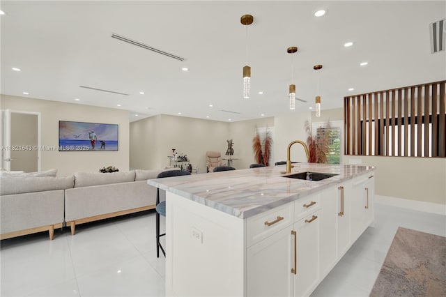 14625 SW 83rd Pl, Palmetto Bay, FL 33158 - kitchen with open floor plan, light stone countertops, white cabinets, light tile patterned floors, and recessed lighting