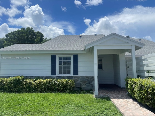 13766 SW 147th Cir Ln Unit 1-20, Miami, FL 33186 - view of front of home featuring roof with shingles, a front lawn, and stone siding