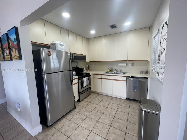 13766 SW 147th Cir Ln Unit 1-20, Miami, FL 33186 - kitchen with stainless steel appliances, light countertops, light tile patterned flooring, and recessed lighting