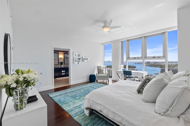 6899 Collins Ave Unit 2707, Miami Beach, FL 33141 - bedroom with a water view, multiple windows, dark wood-style floors, and a ceiling fan