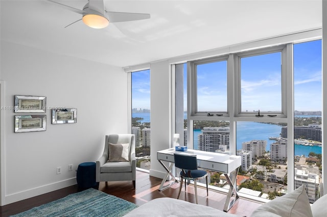 6899 Collins Ave Unit 2707, Miami Beach, FL 33141 - bedroom featuring expansive windows, multiple windows, wood finished floors, a water view, and ceiling fan