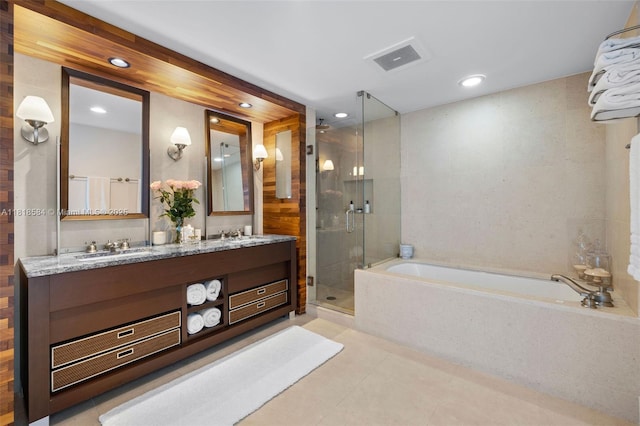 6899 Collins Ave Unit 2707, Miami Beach, FL 33141 - bathroom featuring a bath, a shower stall, double vanity, recessed lighting, and tile patterned flooring