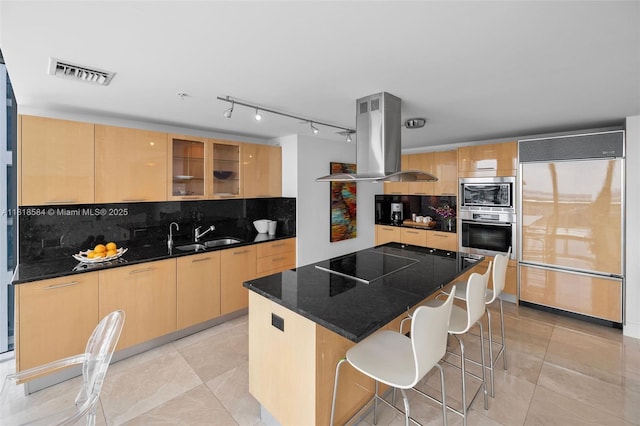 6899 Collins Ave Unit 2707, Miami Beach, FL 33141 - kitchen with built in appliances, island range hood, tasteful backsplash, a center island, and glass insert cabinets