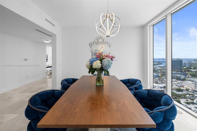 6899 Collins Ave Unit 2707, Miami Beach, FL 33141 - dining room featuring healthy amount of natural light, a chandelier, a view of city, and floor to ceiling windows