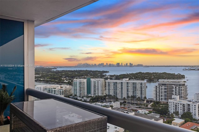6899 Collins Ave Unit 2707, Miami Beach, FL 33141 - balcony at dusk featuring a view of city and a water view
