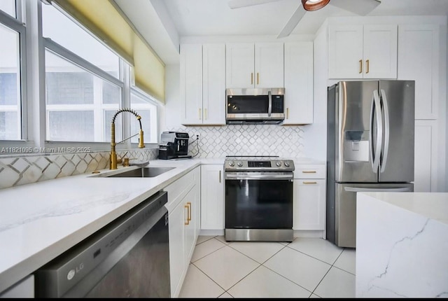1920 S Ocean Dr Unit 901, Fort Lauderdale, FL 33316 - kitchen featuring stainless steel appliances, white cabinets, and light tile patterned floors