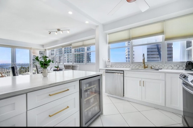 1920 S Ocean Dr Unit 901, Fort Lauderdale, FL 33316 - kitchen with dishwasher, beverage cooler, stove, backsplash, and white cabinetry