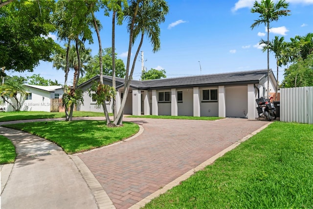 930 NE 182nd Ter, North Miami Beach, FL 33162 - view of front of house featuring decorative driveway, stucco siding, and roof with shingles