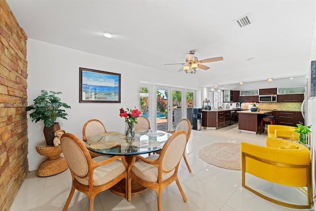 930 NE 182nd Ter, North Miami Beach, FL 33162 - dining room with a ceiling fan, french doors, and light tile patterned flooring