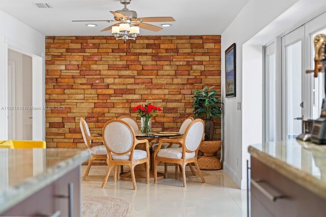 930 NE 182nd Ter, North Miami Beach, FL 33162 - dining room with brick wall, ceiling fan, light tile patterned floors, and recessed lighting