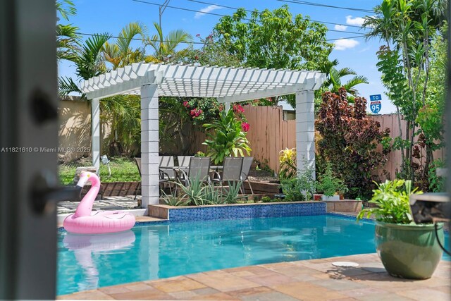 930 NE 182nd Ter, North Miami Beach, FL 33162 - view of swimming pool with a pergola