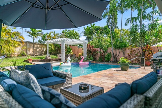 930 NE 182nd Ter, North Miami Beach, FL 33162 - view of swimming pool featuring an outdoor living space, a fenced backyard, and a pergola
