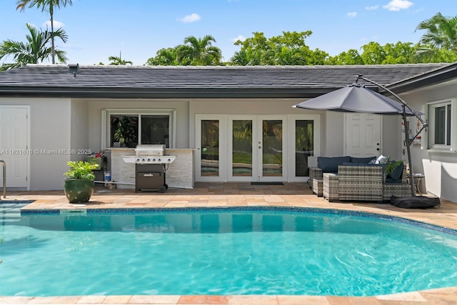 930 NE 182nd Ter, North Miami Beach, FL 33162 - outdoor pool featuring french doors, a grill, an outdoor living space, and a patio area