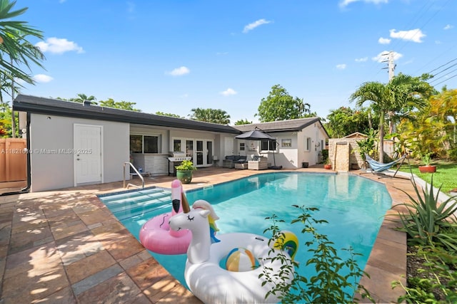 930 NE 182nd Ter, North Miami Beach, FL 33162 - outdoor pool with french doors, a patio, area for grilling, and outdoor lounge area