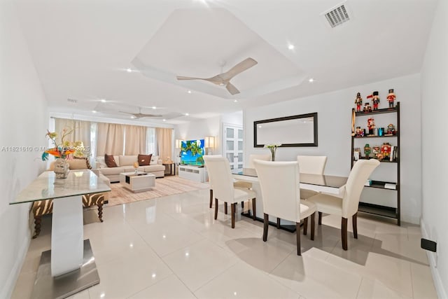 930 NE 182nd Ter, North Miami Beach, FL 33162 - dining space with ceiling fan, light tile patterned floors, and a tray ceiling