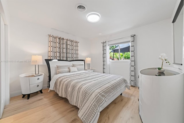 930 NE 182nd Ter, North Miami Beach, FL 33162 - bedroom with light wood-style flooring and baseboards