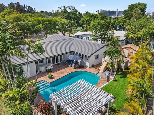 930 NE 182nd Ter, North Miami Beach, FL 33162 - swimming pool with a fenced backyard, a patio area, and view of scattered trees