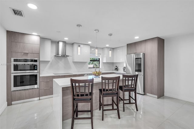 7100 Mcclellan St, Hollywood, FL 33024 - kitchen featuring stainless steel appliances, wall chimney exhaust hood, modern cabinets, and recessed lighting