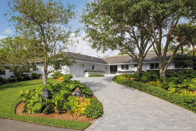 11100 Paradela St, Coral Gables, FL 33156 - ranch-style home featuring decorative driveway, an attached garage, stucco siding, and a front lawn