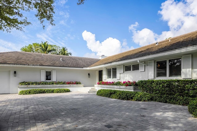 11100 Paradela St, Coral Gables, FL 33156 - view of front of property with stucco siding and decorative driveway