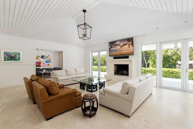 11100 Paradela St, Coral Gables, FL 33156 - living area with lofted ceiling, a chandelier, and a fireplace with raised hearth