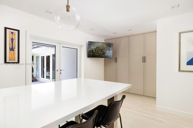 11100 Paradela St, Coral Gables, FL 33156 - kitchen featuring a kitchen breakfast bar, light wood-style floors, pendant lighting, and gray cabinets
