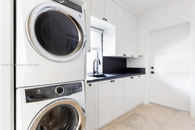 11100 Paradela St, Coral Gables, FL 33156 - laundry area featuring stacked washer and clothes dryer and cabinet space