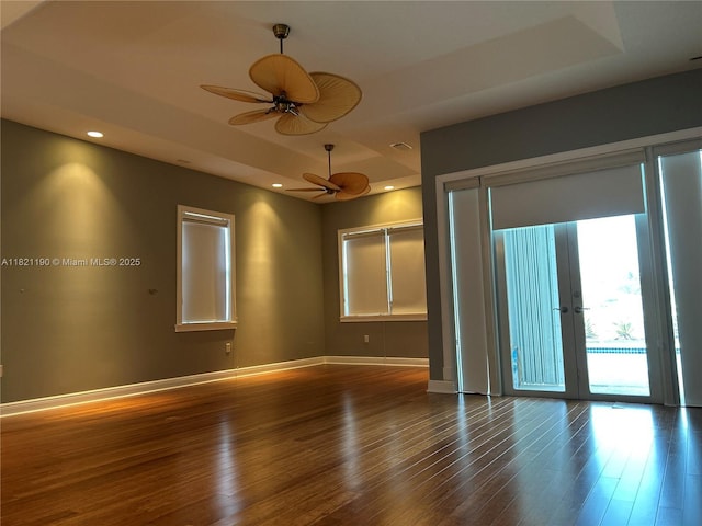 2640 Fairways Dr, Homestead, FL 33035 - spare room with a tray ceiling, a ceiling fan, wood finished floors, french doors, and recessed lighting