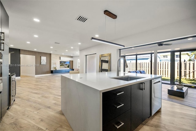 3910 NE 27th Ter, Lighthouse Point, FL 33064 - kitchen with open floor plan, modern cabinets, a kitchen island with sink, light wood-style flooring, and recessed lighting