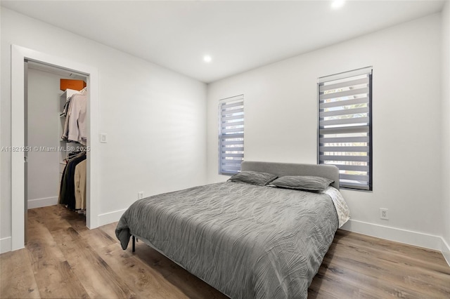 3910 NE 27th Ter, Lighthouse Point, FL 33064 - bedroom featuring a spacious closet, wood finished floors, and recessed lighting