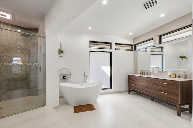 3910 NE 27th Ter, Lighthouse Point, FL 33064 - full bath featuring double vanity, a stall shower, a freestanding tub, and recessed lighting