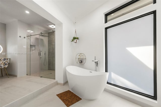 3910 NE 27th Ter, Lighthouse Point, FL 33064 - bathroom with a shower stall, a soaking tub, and recessed lighting