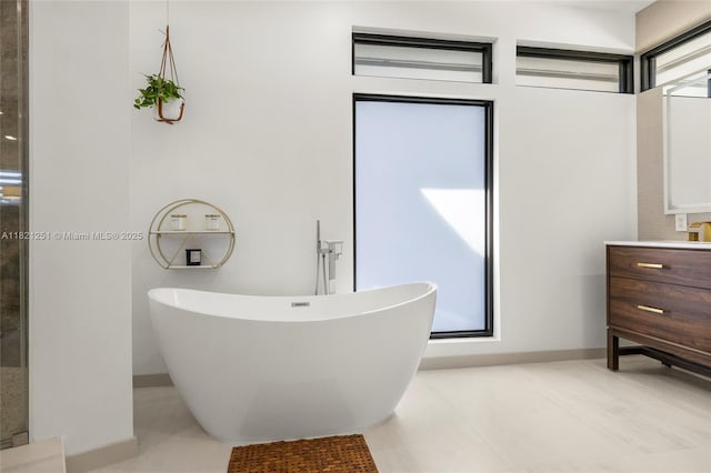 3910 NE 27th Ter, Lighthouse Point, FL 33064 - bathroom featuring a soaking tub, vanity, and tile patterned floors