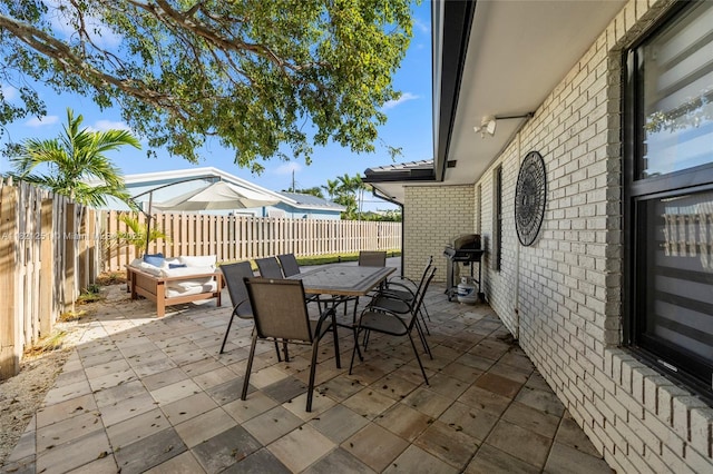3910 NE 27th Ter, Lighthouse Point, FL 33064 - fenced backyard featuring a grill, a patio, outdoor dining area, and outdoor lounge area