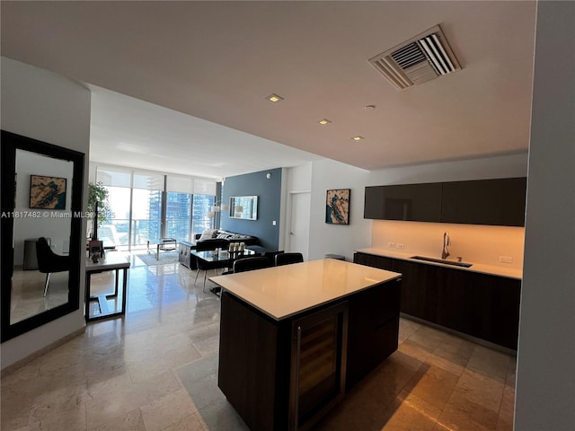 88 SW 7th St Unit 2209, Miami, FL 33130 - kitchen with expansive windows, light countertops, a center island, dark cabinets, and modern cabinets