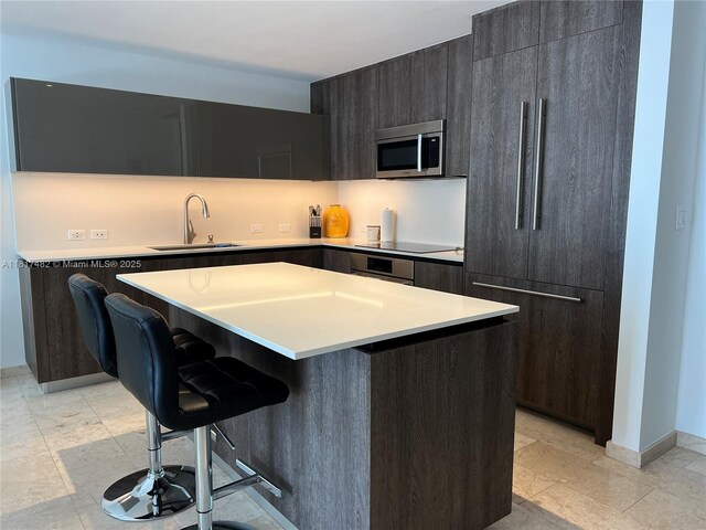 88 SW 7th St Unit 2209, Miami, FL 33130 - kitchen with stainless steel microwave, wall oven, a kitchen bar, paneled refrigerator, and a center island