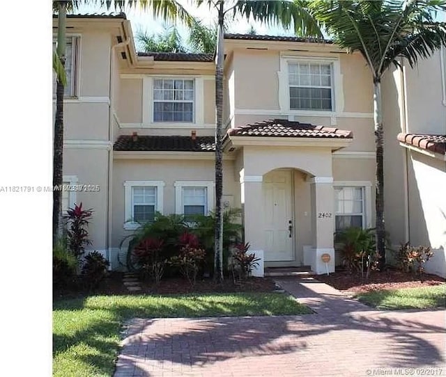 2402 NE 41st Pl, Homestead, FL 33033 - view of property featuring stucco siding and a tiled roof
