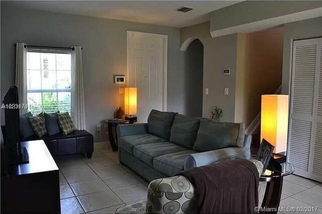 2402 NE 41st Pl, Homestead, FL 33033 - living room featuring light tile patterned floors and arched walkways