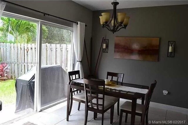 2402 NE 41st Pl, Homestead, FL 33033 - dining area with a chandelier and light tile patterned floors