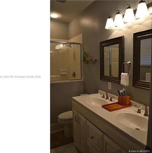 2402 NE 41st Pl, Homestead, FL 33033 - bathroom with an enclosed shower and double vanity