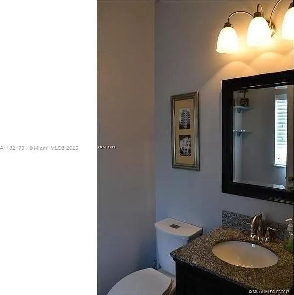 2402 NE 41st Pl, Homestead, FL 33033 - half bath featuring vanity and toilet