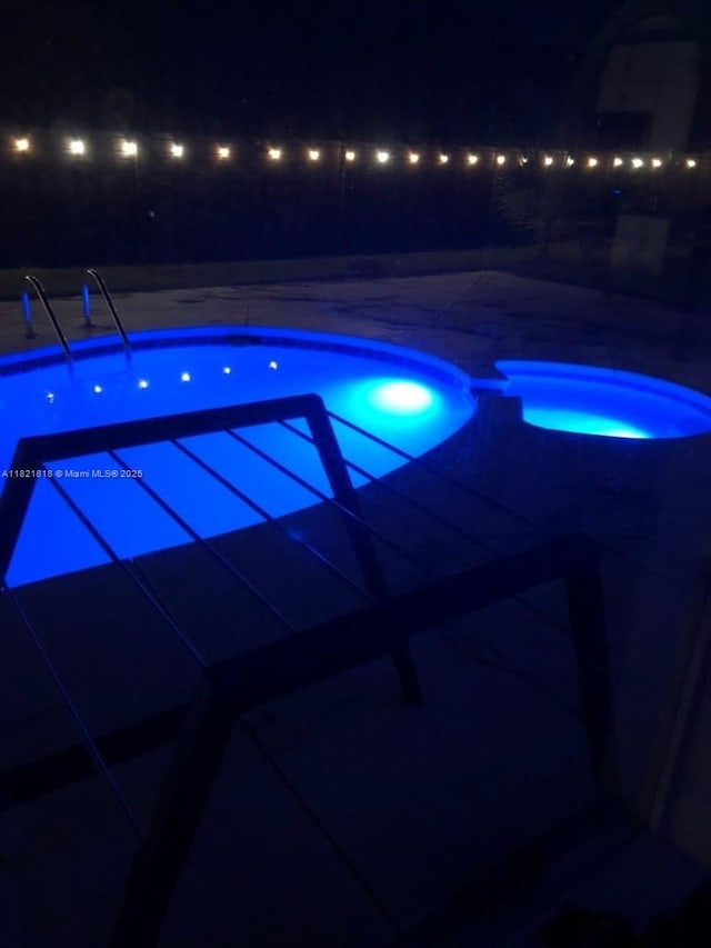 120 Hombre Cir Fl, Panama City Beach, FL 32407 - pool at twilight featuring a patio