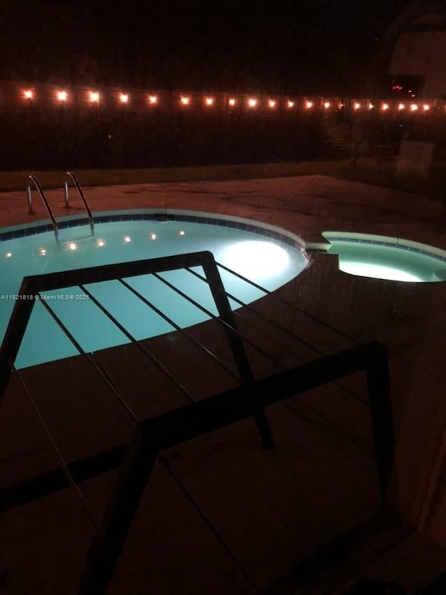 120 Hombre Cir Fl, Panama City Beach, FL 32407 - pool at night featuring a patio area