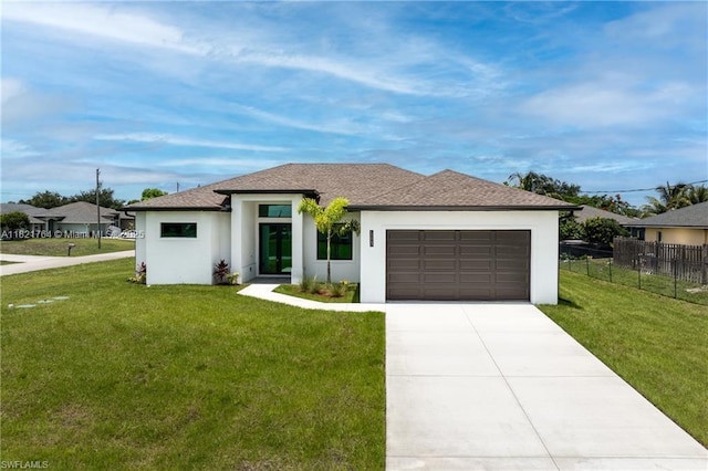 1003 Casino Ave, Lehigh Acres, FL 33971 - prairie-style home featuring an attached garage, stucco siding, concrete driveway, and roof with shingles