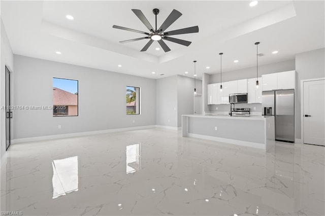 1003 Casino Ave, Lehigh Acres, FL 33971 - unfurnished living room featuring recessed lighting, light marble finish flooring, a raised ceiling, and a ceiling fan