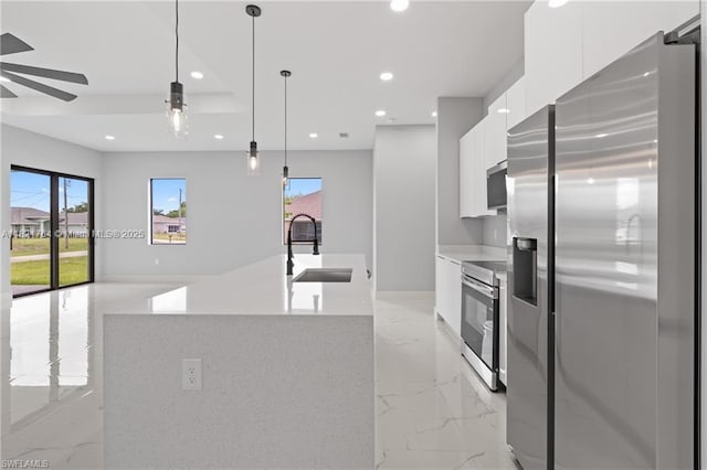 1003 Casino Ave, Lehigh Acres, FL 33971 - kitchen with stainless steel appliances, modern cabinets, light marble finish floors, white cabinetry, and recessed lighting